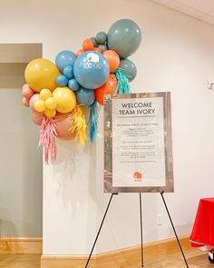 there is a welcome sign and balloons in the room