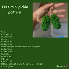 a hand holding two green stuffed animal keychains with the words free mini pickle pattern