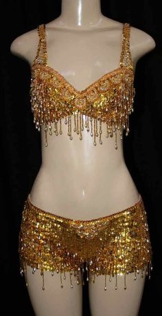 a mannequin with gold sequins and chains on it's torso