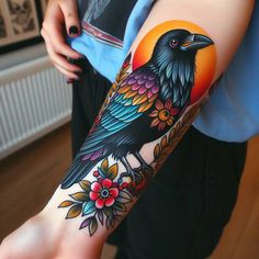 a person with a tattoo on their arm and leg, has a black bird sitting on top of flowers