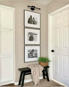 three framed pictures hang on the wall above a bench in front of a white door