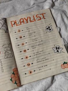 an open halloween playlist book on a bed