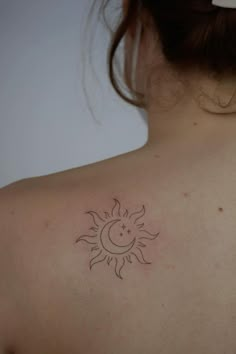 a woman with a sun and moon tattoo on her back