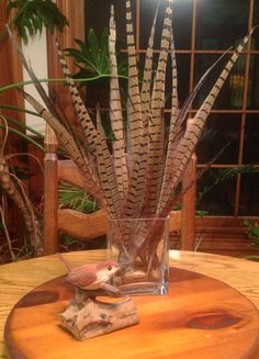 a wooden table topped with a vase filled with plants