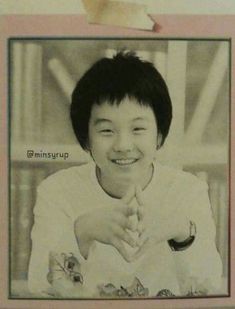 an old photo of a woman smiling and holding her hand up to the camera,