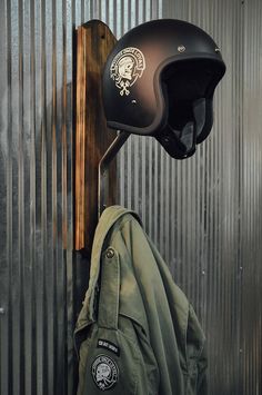 a motorcycle helmet and jacket hanging on a wall