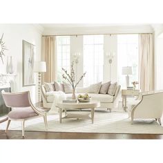 a living room filled with white furniture and lots of window sill curtains on the windowsill