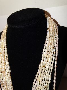 "89 grams weight, Vintage 5 Strands of 46\" lenght each, Rice Pearl Necklace. Excellent condition." Luxury Meenakari Pearl Necklace In Temple Jewelry Style, Traditional Luxury Pearl Necklace For Women, Luxury Traditional Pearl Necklace For Women, Luxury Bollywood Pearl Necklace For Ceremonial Occasions, Luxury Temple Jewelry Style Pearl Necklace, Luxury Bollywood Pearl Necklace For Ceremonies, Luxury Traditional Women's Pearl Necklace, Pearls Jewelry Indian Kameswari Jewellers, Pearl Gold Necklace Indian Totaram Jewelers