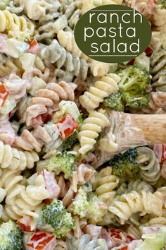 a pasta salad with broccoli and tomatoes in it is ready to be eaten