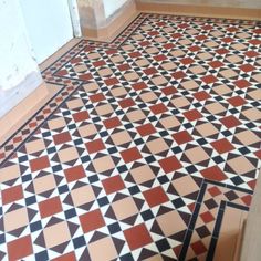 the floor is covered with black and white tiles, which are red and brown in color