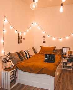 a bed room with a neatly made bed and string lights