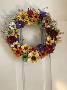 a colorful wreath hanging on the front door