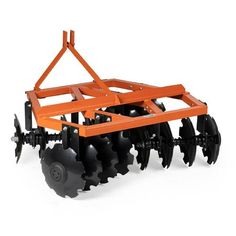 an orange and black tractor mounted on top of a plow with two blades attached to it