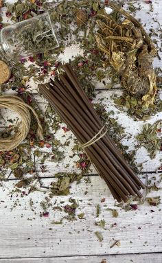 various herbs and incense sticks on a white wooden table