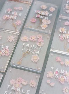 there are many flowers on the table with words written in them and some daisies