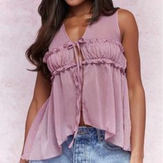 This Mauve Purple Top Brings A Touch Of Elegance With Its Ruffle And Frill Details. The V-Neckline And Asymmetrical Hem Create A Stylish, Dynamic Look, While The Sleeveless Design Adds A Modern Flair. Crafted From Semi-Sheer Chiffon, This Loose-Fit Top Offers A Regular Length And A Lightweight Feel, Perfect For Layering Or Wearing Alone. The Unlined Body Enhances Its Delicate, Airy Quality, Making It An Ideal Choice For Both Casual And Dressy Occasions. Flirty V-neck Tank Top For Summer, Flirty Sleeveless Camisole For The Beach, Summer V-neck Camisole For Parties, Flirty V-neck Summer Blouse, Summer Blouse With V-neck And Vest Detail, Flirty Sleeveless Spring Blouse, Flirty Sleeveless Blouse For Spring, Mauve Purple, Loose Fitting Tops