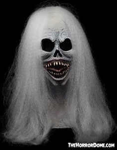 a creepy mask with long white hair and teeth