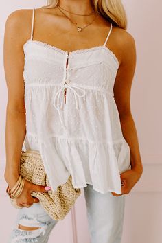 - Perfect for a sunny day, this adorable top pairs perfectly with a sun-kissed glow! - Unlined dot textured material with lace trimmed accents - A v-cut neckline with a 3 buttoned front - Thin, adjustable spaghetti straps - A functional drawstring under the bust - A flowy silhouette that ends in a ruffled hemline Babydoll Tops, Babydoll Tank Top, Babydoll Tank, Summer 24, Senior Pics, Babydoll Top, V Cut, V Cuts, Sun Kissed