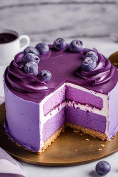 a cake with purple frosting and blueberries on top