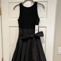 Beautiful Nwt Ralph Lauren Black Party Dress. Black Jersey Knit Bodice With Black Taffeta Skirt. Long Sash Wraps Around Waist To Tie Into A Bow. Beautiful "V" Back. Midi Length - 40" Long From Top Of Shoulder To Bottom Of Hem. Original Price: $198.00 Black Midi Length Holiday Dress, Black Midi Holiday Dress, Black Midi Dress For Holidays, Black Midi Dress For Black-tie Events, Black A-line Holiday Dress, Black A-line Dress For Holidays, Holiday Black A-line Dress, Black Fitted Midi Dress For Black-tie Events, Holiday Black Dressy Midi Dress