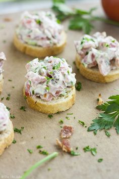 small crackers topped with crab salad and parsley