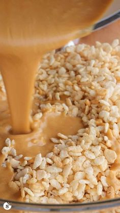 a glass bowl filled with oatmeal and caramel being poured into it