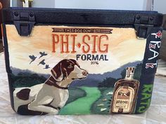 a bag with a dog on it sitting on top of a bed next to a bottle