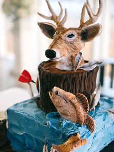 there is a cake decorated to look like a deer and two fish on top of it