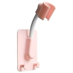 a pink toothbrush holder on a white background with a light pink wall mounted toothbrush