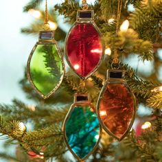 three ornaments hanging from a christmas tree