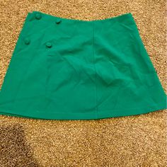 Wrap Around Skirt With Buttons In The Side, It Does Come With A Green Blazer That Is Sold Separately. Never Worn, Material Is 100% Polyester Fitted Casual Skirt With Side Buttons, Casual Fitted Skirt With Side Buttons, Fitted Green Skirt With Buttons, Casual Green Buttoned Skirt, Green Skirt With Button Closure, Chic Green Skirt With Button Closure, Casual Green Skirt With Buttons, Green Mini Skirt With Button Closure, Fitted Green Skirt With Button Closure