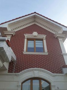 a red brick building with an open window