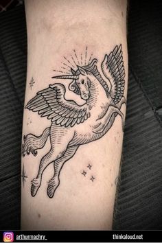 a black and white photo of a tattoo on the leg of a person with an angel