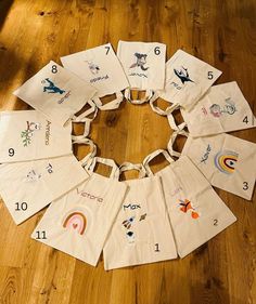 a group of white bags with numbers and pictures on them sitting on a wooden floor