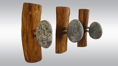 three wooden handles with rocks on them