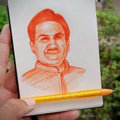 a pencil drawing of a man's face in red and orange ink on white paper