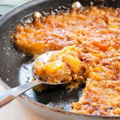 a skillet with some food in it and a spoon sticking out of the pan