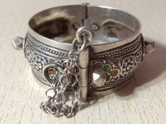 A superb old Berber silver bracelet from Morocco. The surface of the bangle has been finely hand-etched with a design combining lines with enamel, and the surface as well as interior have both obtained a very rich patina from wear and usage. It opens and closes with a pin. Inner diameter : 5,6 cm (2,2 inches) Width : 2,8 cm (1,1 inches) Weight : 73,6 g Heavy Antique Silver Bangle Bracelet, Antique Silver Bracelet For Festivals, Ornate Stamped Bangle Bracelet, Heavy Silver Bracelets For Ceremonial Occasions, Antique Silver Stamped Bangle Bracelet, Ornate Stamped Bracelet Jewelry, Antique Oxidized Bangle Bracelet, Ornate Silver Bracelets For Festivals, Traditional Stamped Bangle Bracelet