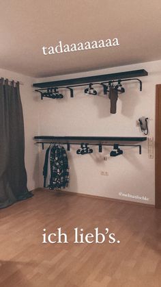 there is a room with clothes hanging on the wall