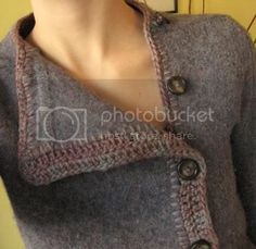 a woman is wearing a gray sweater with buttons