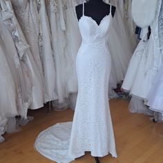 a white wedding dress on display in a bridal gown shop