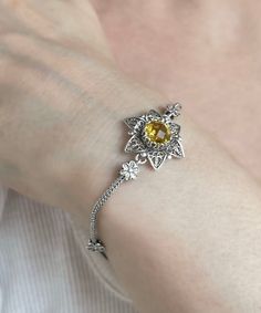 Citrine Silver Lily Flower Women Cute Bracelet, 925 Sterling Silver Handmade Artisan Crafted Filigree Vintage Unique Chain Bracelet Jewelry bracelet for girl, protection bracelet, ornate tiny bracelet, magnolia bracelet, artisan crafted gift, layering bracelet, bridesmaid gift her, natural yellow stone, artisan crafted gift, silver gift for her Gemstone: Yellow Citrine 8mm. Material: 925 Sterling Silver ( NICKEL FREE ) Bracelet Length: 18 cm + 5 cm // 7 Inches + 2 Inches Extender Bracelets Width: 2.1 cm // 0.83 Inches Indulge in the epitome of opulence with the Citrine Silver Lily Flower Women Cute Bracelet. This exquisite masterpiece transcends mere jewelry; it is a timeless work of art meticulously crafted for the discerning connoisseur of luxury. Fashioned from 925 sterling silver, this Tiny Bracelet, Flower Women, Filigree Bracelet, Cute Bracelet, Silver Chain Style, Protection Bracelet, Free Bracelet, Yellow Citrine, Yellow Stone