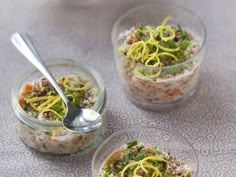 three glass bowls filled with food on top of a table