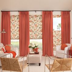 a living room with red curtains and white furniture