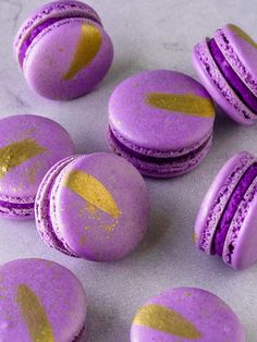 purple macaroons with gold paint splattered on them