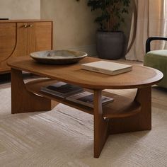 a wooden table with a book on it in a living room next to a chair