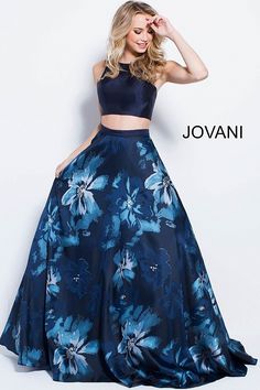 Feel the ocean breeze in Jovani 58610. This tropical two-piece gown includes a mikado top, with a high neckline, and tank straps, which lead the open square back, with zipper closure. The full, floor-length, A-line skirt blossoms with a vibrant floral print. Plan a romantic getaway in this gown at a wedding, prom, or military ball. 2 Piece Dress Formal, Prom Ballgown, Two Piece Prom, Crop Top Lehenga, Printed Prom Dresses, Two Piece Gown, 2 Piece Dress, Flower Skirt, فستان سهرة