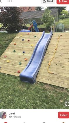 an inflatable slide is laying on top of a wooden board with plastic balls