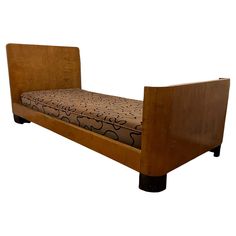 a wooden bed frame with an upholstered design on the bottom and back sides