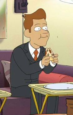 a man in a suit eating pizza at a table